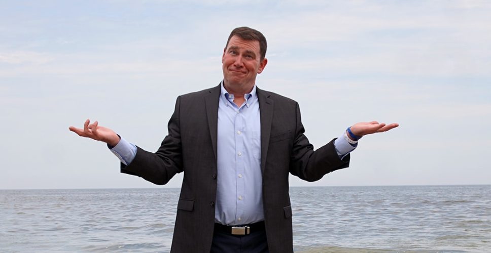 Bob Kulhan standing in front of the ocean